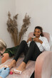 © Alina Hvostikova/Stocksy - Smiling black client during pedicure