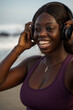 © Jovo Jovanovic/Stocksy - Woman laughing while holding her headphones