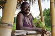 © Jovo Jovanovic/Stocksy - Happy woman in sportswear relaxing with coconut water