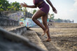 © Jovo Jovanovic/Stocksy - Woman running up the stairs covered with sand