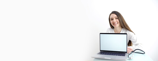 woman is holding laptop computer on white Studio background Doctor banner. Happy nurse in blue gloves, clipboard hospital wearing scrubs, provide checkup, examine patient in clinic. Medical care