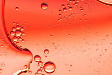 Abstract Red Background With Oil Drops On Water