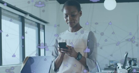 Poster - Animation of connected icons over african american woman using cellphone in office