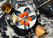 © Javier Díez/Stocksy - Bottle caps and tins on plate near bread and fork