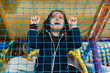 © Ezequiel Giménez/Stocksy - Girl crying behind net on playground