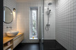 © Andriy Bezuglov/Stocksy - Small modern bathroom with a dark floor, mirror frame, and hardware