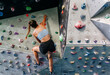 © Marco Govel/Stocksy - Woman climber on climbing wall