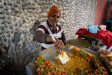 A street vendor cooks vegetarian food on the street in Kolkata, India