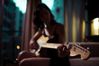 © Ibai Acevedo/Stocksy - Cinematic close up portrait of woman playing guitar