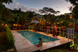 © Raymond Forbes LLC/Stocksy - Sunset at swimming pool with family together in Costa Rica