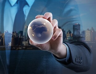 Canvas Print - Businessman holding globe in global business concept