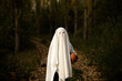 © Albert Martinez/Stocksy - child hiding under a sheet on halloween