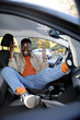 © Jovo Jovanovic/Stocksy - Portrait of carefree man lying and gesturing on front seat of the car