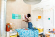 © Alba Vitta/Stocksy - teen decorating  her bedroom