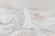 © Sonja Lekovic/Stocksy - white bed sheets and pillows and white brick wall