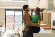 © Alba Vitta/Stocksy - Couple hugging at kitchen
