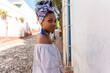 © Luis Velasco/Stocksy - Street Portrait Of Young Black Cuban Woman With Traditional Headscarf