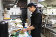 © Diego Martin/Stocksy - Asian man working in kitchen