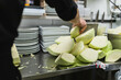 © Diego Martin/Stocksy - Unrecognizable person working in a kitchen