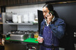 © Diego Martin/Stocksy - Asian man in a kitchen with smarphone