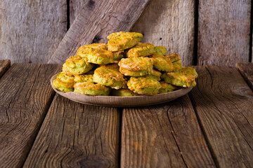 Wall Mural - homemade baked scone cakes from fresh ramson leaves and cheese, old wooden texture