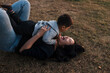 © Rob and Julia Campbell/Stocksy - Mom and child rolling and playing in the grass outside.