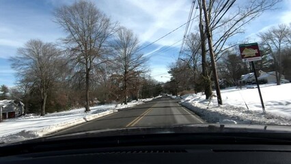 Wall Mural - driving through snow covered suburban town after the snow storm