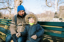 Little Boy And Grandfather Sitting On Bench At Boston Common