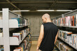 © Laura Herrera/Stocksy - Man walks around library hall