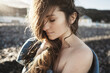 © Vradiy Art/Stocksy - Tender portrait of young woman on the beach