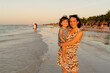 © Gemma can fly/Stocksy - Happy woman holding daughter on beach