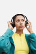 © María Soledad Kubat/Stocksy - Modern young woman in wireless headphones listening to music