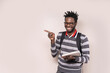 African Student Pointing at Copy Space with a Smile