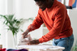 © Studio Marmellata/Stocksy - Crop man ironing clothes