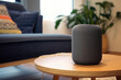 Smart speaker, virtual assistant with AI voice recognition, on a table in a stylish living room