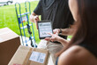 © Sean Locke/Stocksy - Shipment: Woman Signs For Delivery On Tablet
