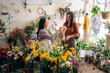 © Santi Nuñez/Stocksy - Florist selling plants and flower to client