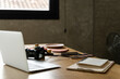 © Alba Vitta/Stocksy - Desk with laptop and camera