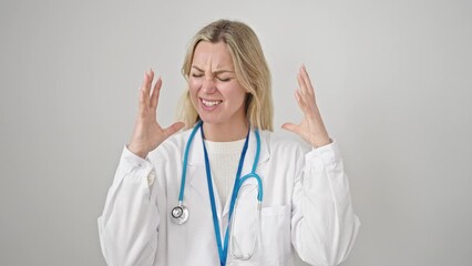 Poster - Young blonde woman doctor angry and stressed over isolated white background