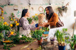 © Santi Nuñez/Stocksy - Florist selling plants and flower to client