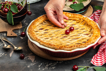 Wall Mural - Delicious Homemade Cherry Pie, Flaky Crust, piece on a plate and the whole homemade cherry pie, place for text, top view