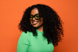 © VICTOR TORRES/Stocksy - Smiling black woman with curly hair