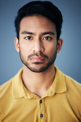 Poster - Focus, serious and portrait of a male in studio with moody, sadness or mental health problem. Tired, concentrating and Indian man model with burnout face expression isolated by gray background.