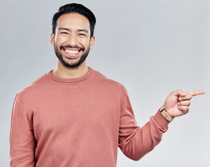 Poster - Smile, space and portrait of Indian man pointing with mockup and product placement isolated on white background. Promotion, information and person showing deal announcement in studio with launch idea