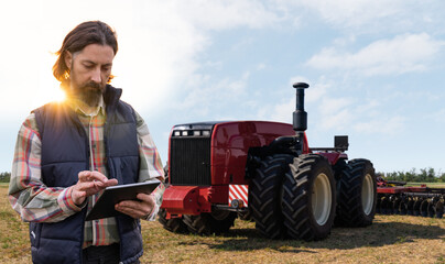 Poster - Farmer with digital tablet controls an autonomous tractor on a smart farm	