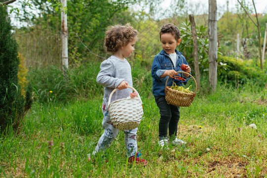 boy and girl with baskets in a easter hunt