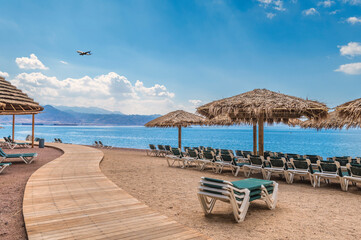 Wall Mural - Morning on central public beach of the Red Sea in Eilat - famous tourist resort and recreational city in Israel. Concept of bliss vacation and happy holiday  