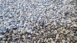 Fototapeta Desenie - Gravel road stone texture. Gray gravel pattern. Closeup road with small rocks background