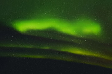 Wall Mural - Green aurora borealis. Dark night starry sky and bright polar lights