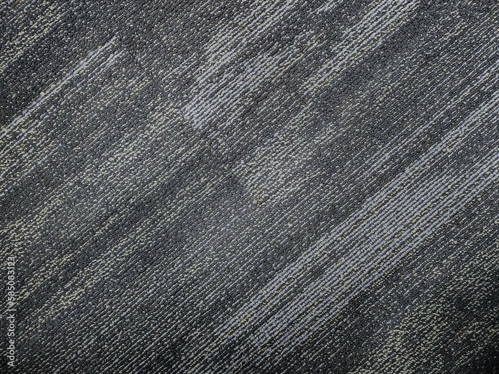 stock photo of a gray-colored, shaded diagonal stripe nylon cut pile textured carpet background. Picture captured at IT company office, Hyderabad, telangana, India.